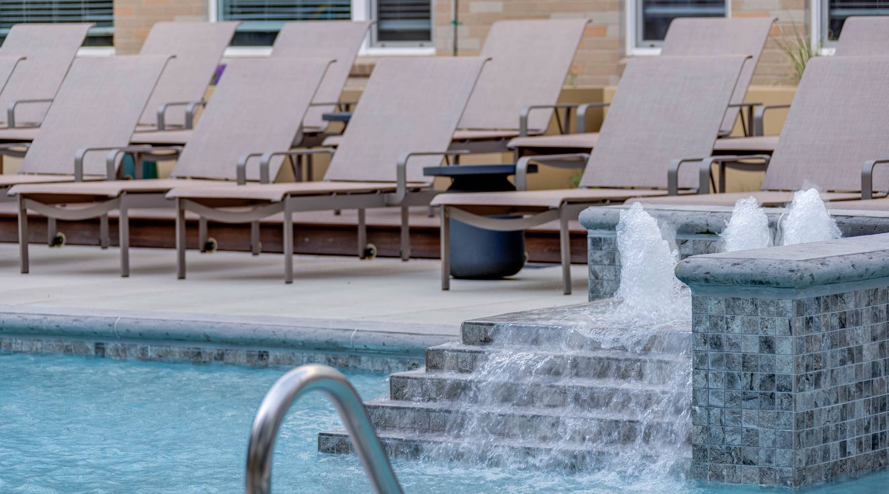 a swimming pool with lounge chairs
