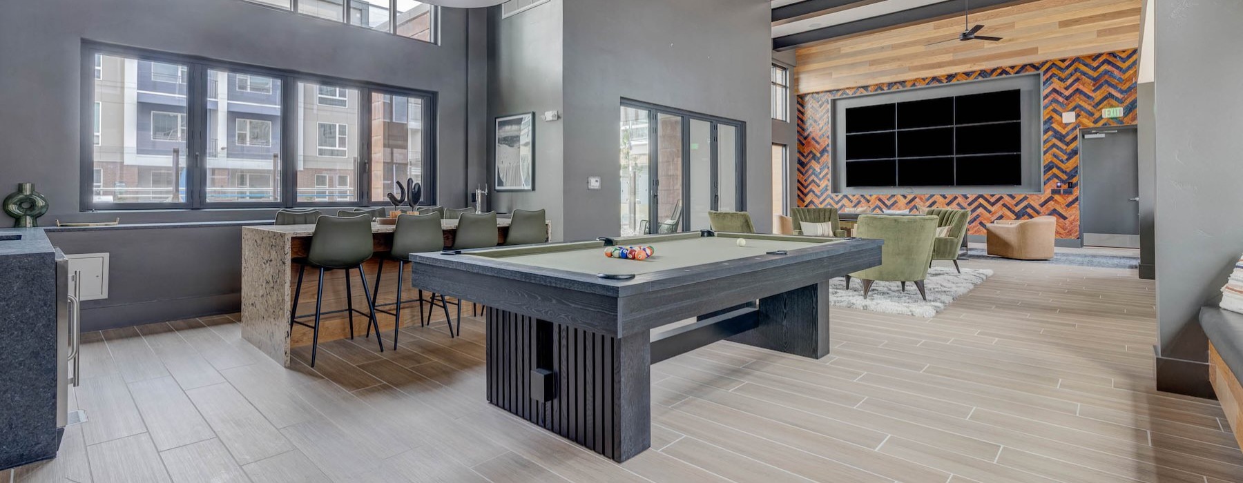 a clubroom with a pool table and chairs