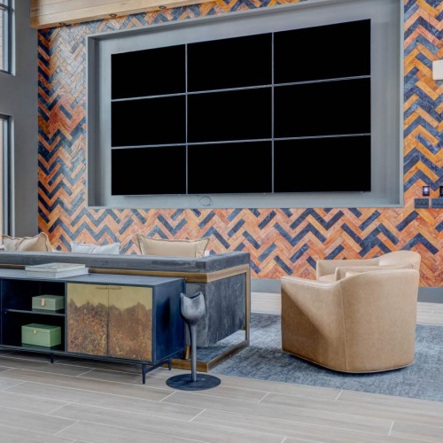 a clubroom with a tv, table and chairs