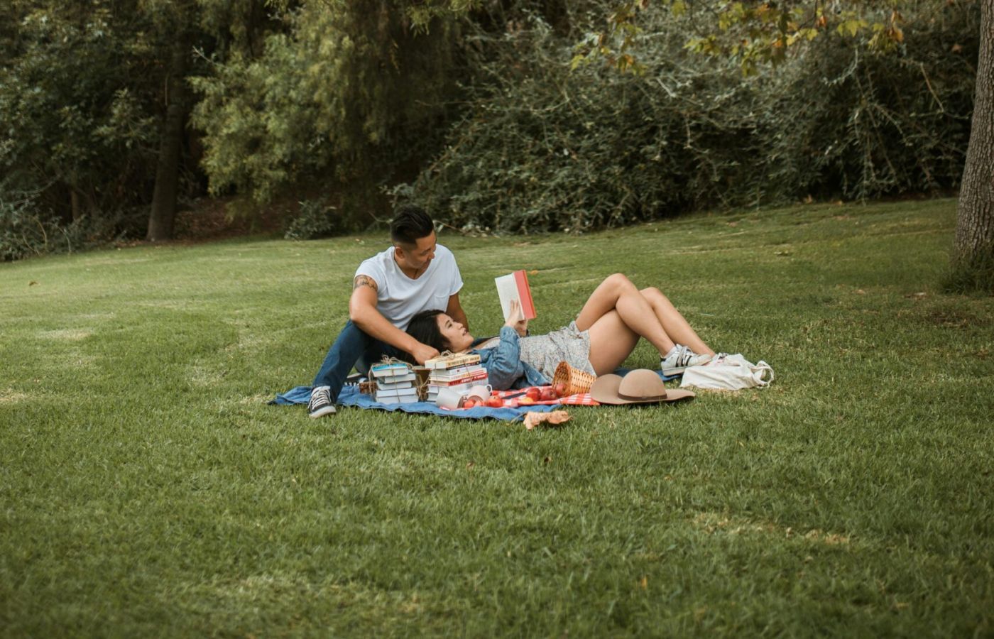 Couple reading and relaxing in a city park