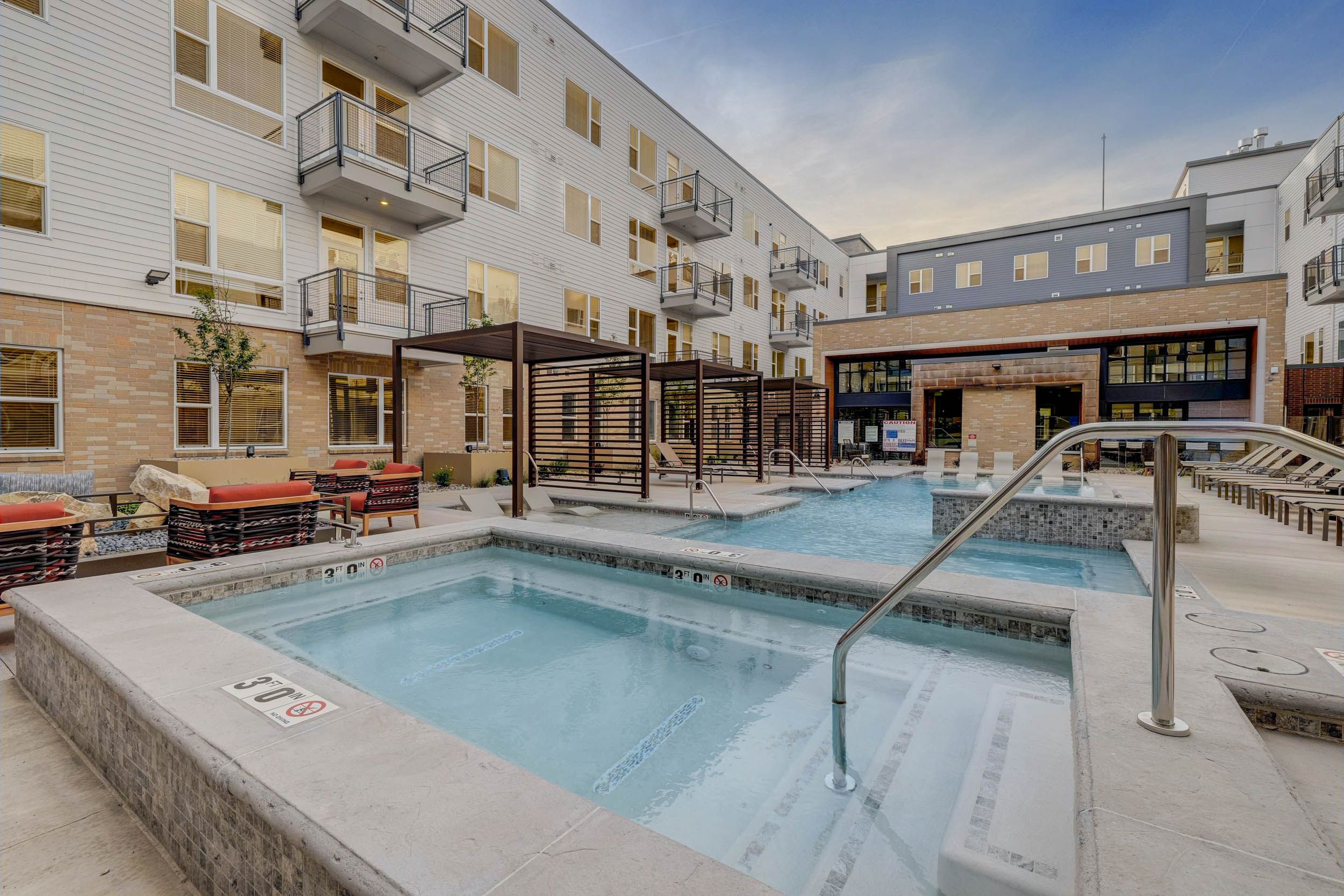 Alta Stone at the Gateway pool patio with lounge seating
